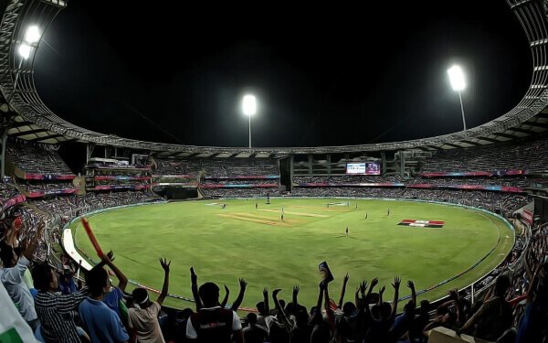 fans cheering for cricket players in an indian cricket ground