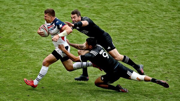 three men playing rugby